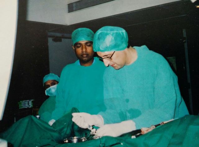 Dr Shantanu Deshpande performing a procedure beside international faculty in the cath lab