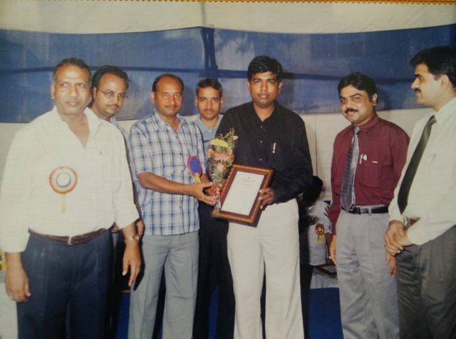 Dr Shantanu Deshpande receiving a framed certificate and bouquet at a felicitation