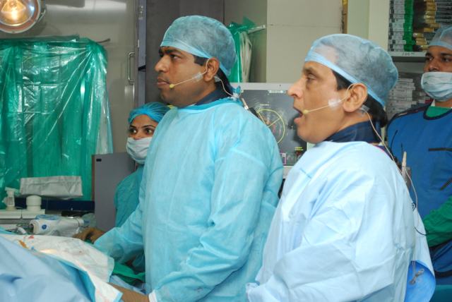 Dr Shantanu Deshpande and a senior colleague wearing headsets during a live case demonstration